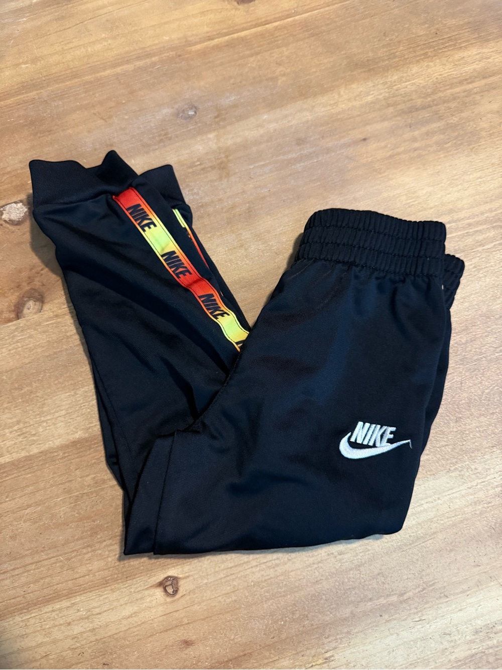 Nike Black Kids Joggers with Red-Orange-Yellow Gradient Tape